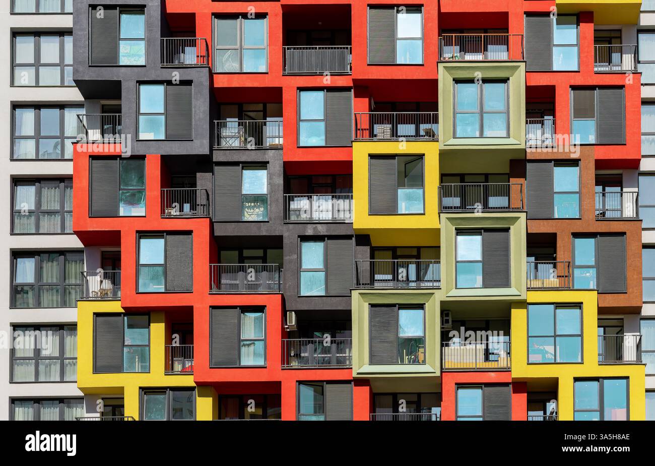 Picture of Modern apartment building with colorful facade, glass windows, and ...