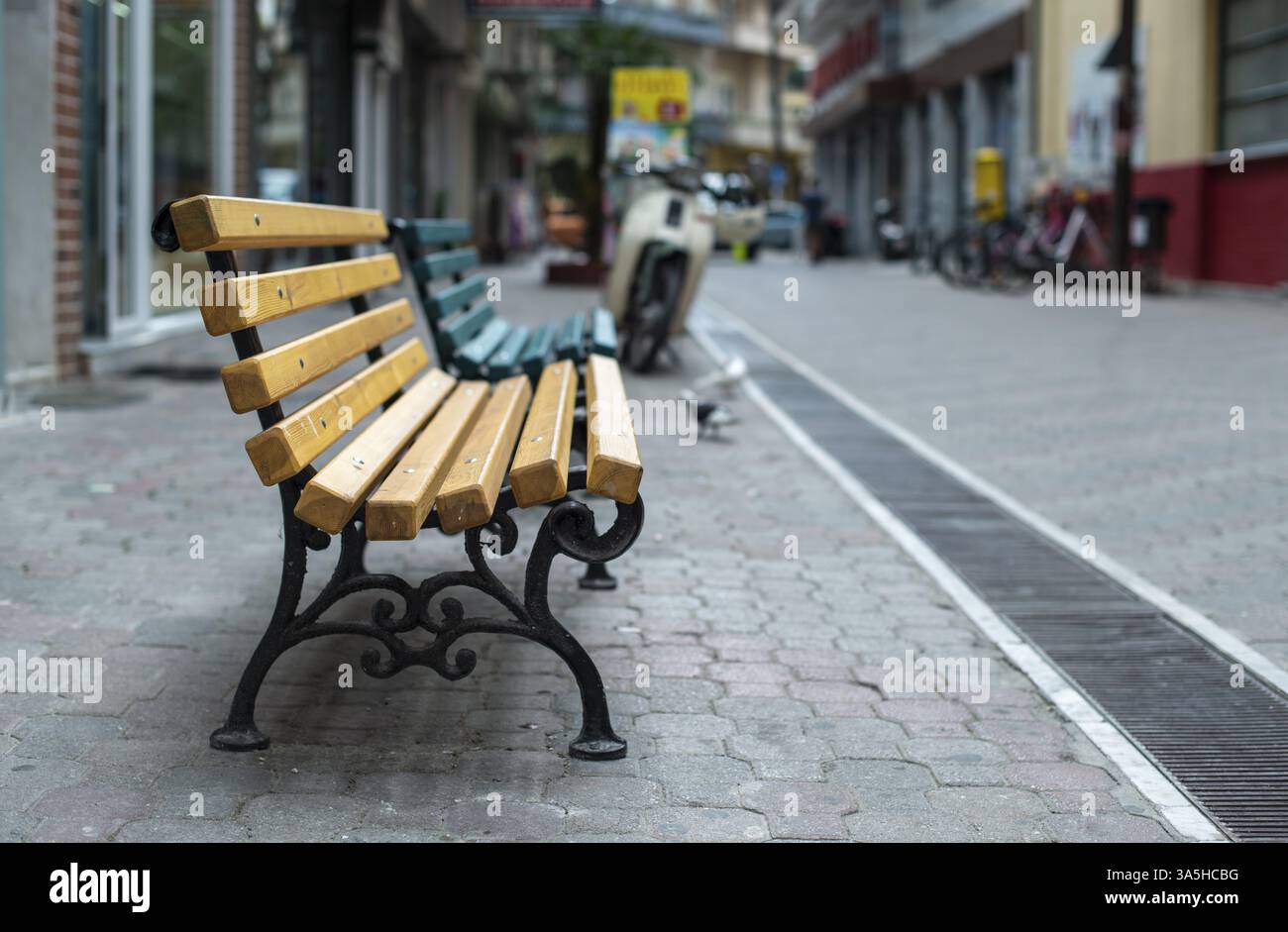 Wooden Bench on the street. No people. Shopping street Stock Photo