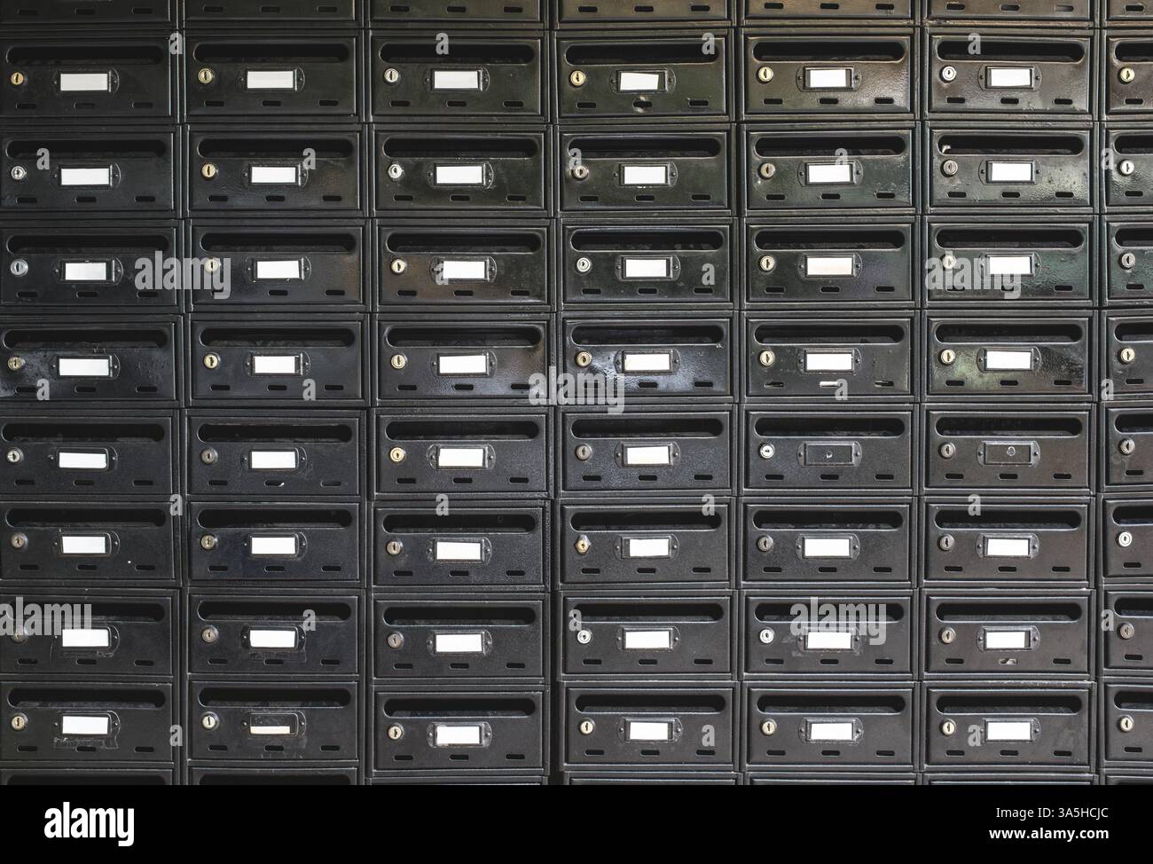 Many Black color mailboxes on wall Stock Photo