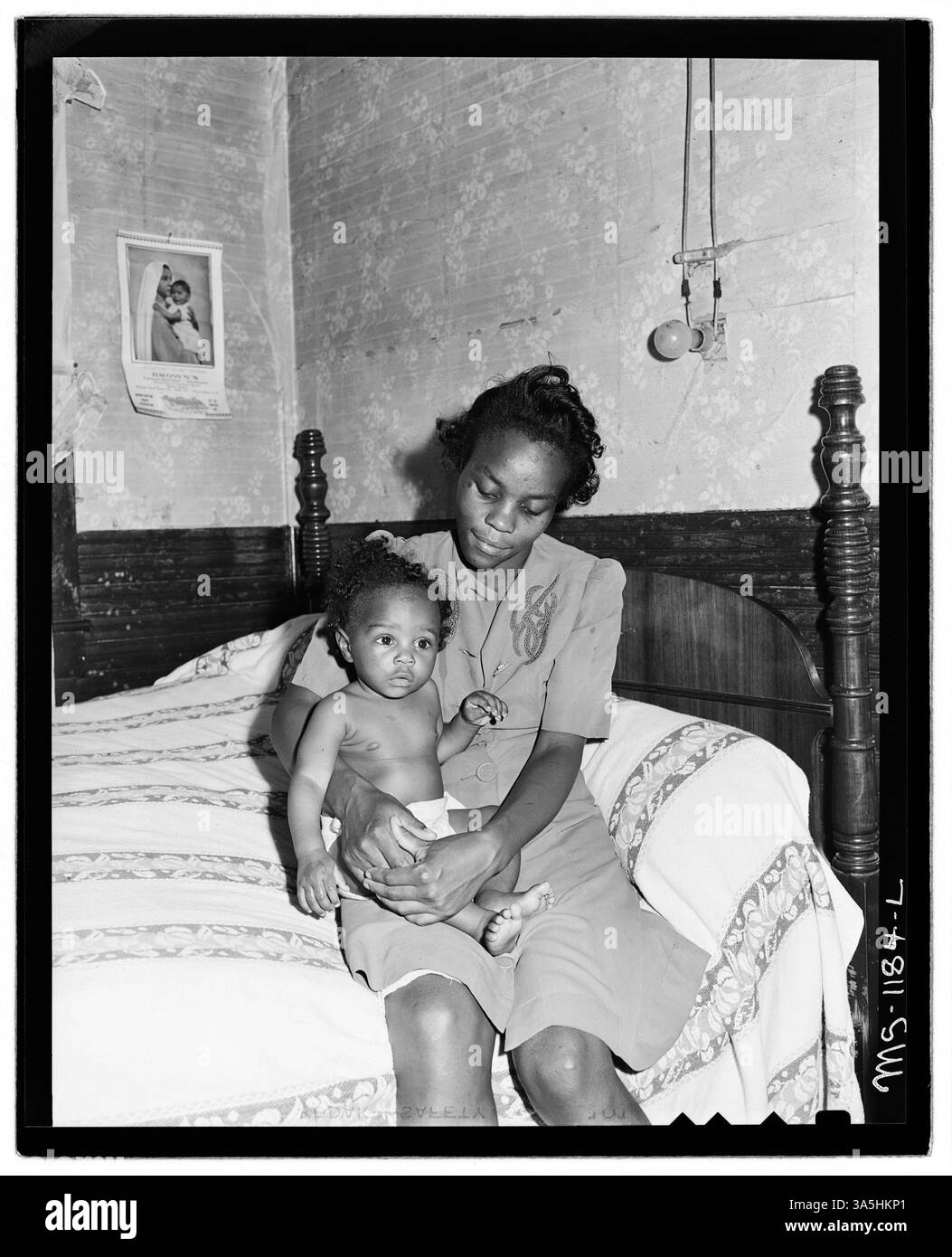 Mrs. Beulah Wady, wife of a miner, and her youngest child in their five