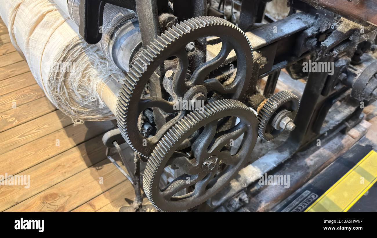 Vintage old weaving loom machine cast metal iron process cloth manufacture. Manufaktura museum in Łódź - Smartphone Captured Stock Image