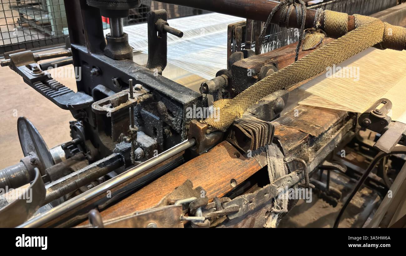 Vintage old weaving loom machine cast metal iron process cloth manufacture. Manufaktura museum in Łódź - Smartphone Captured Stock Image