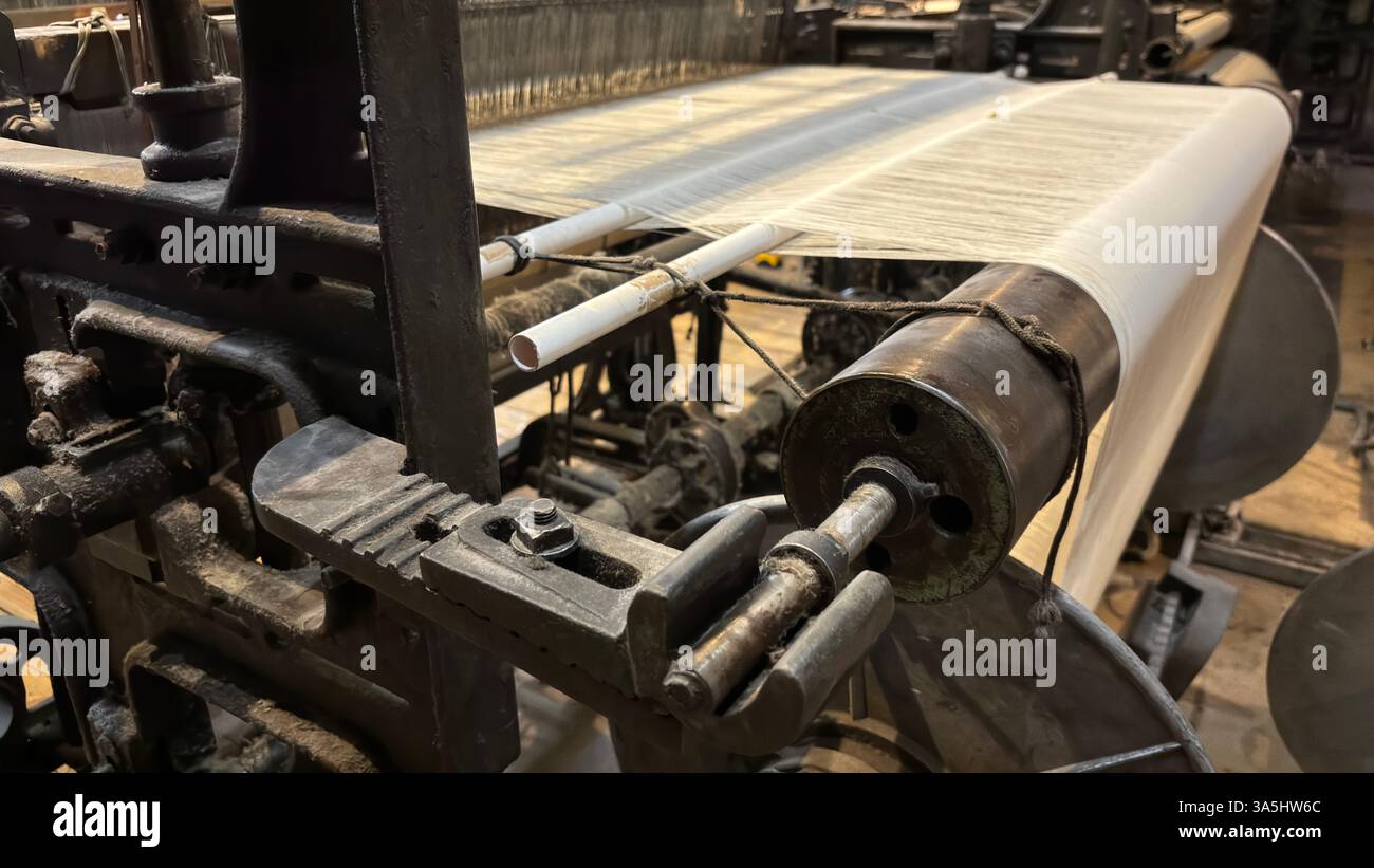 Vintage old weaving loom machine cast metal iron process cloth manufacture. Manufaktura museum in Łódź - Smartphone Captured Stock Image