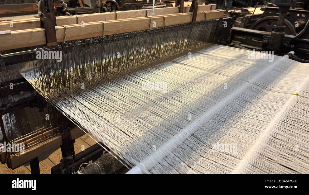 Vintage old weaving loom machine cast metal iron process cloth manufacture. Manufaktura museum in Łódź - Smartphone Captured Stock Image