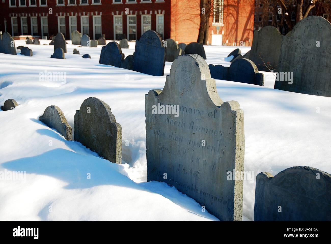Historic tombstones peak out of the snow covered Copps Hill Burial ...