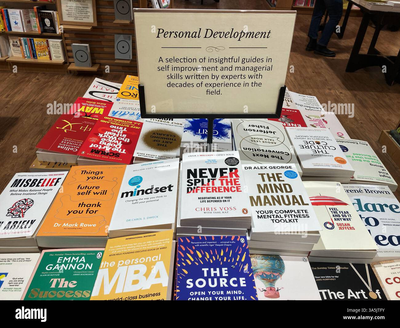 A selection of personal development books for sale at the book store - Smartphone Captured Stock Image