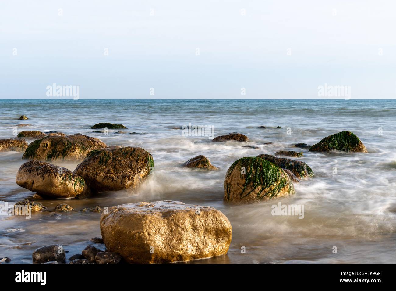 Chalk boulders lit by golden evening sunlight at Birling Gap, East ...