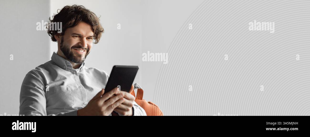Happy mature businessman using tablet pc, looking at screen Stock Photo