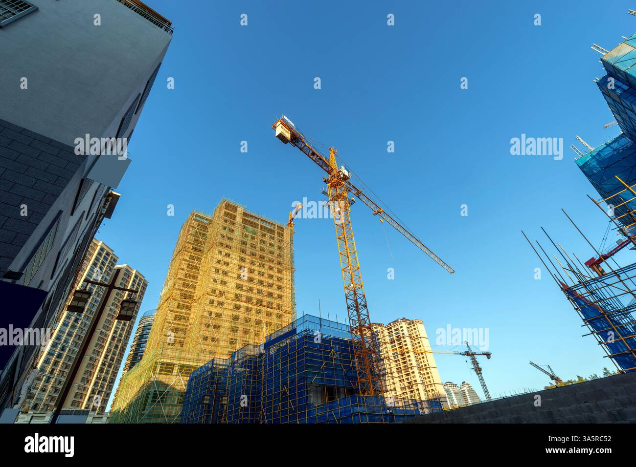 Building construction site, tall skyscrapers and cranes Stock Photo - Alamy