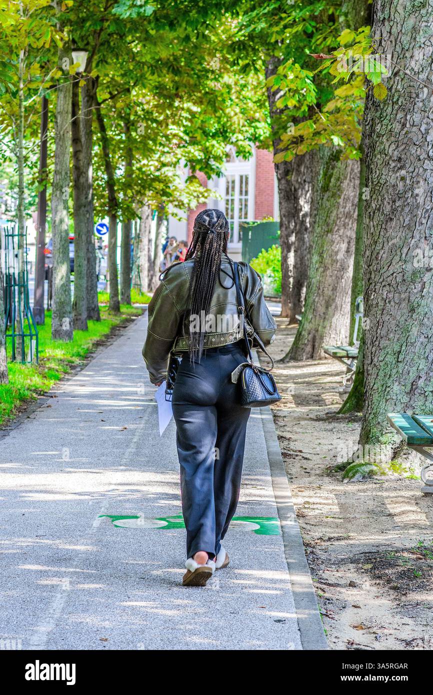 Rear view of French African woman with ling braided hair - Paris, France. Stock Photo