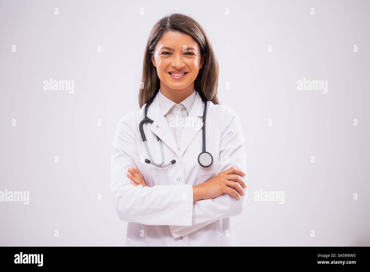 Studio shot portrait of happy female doctor who is satisfied after successful treatment. Stock Photo