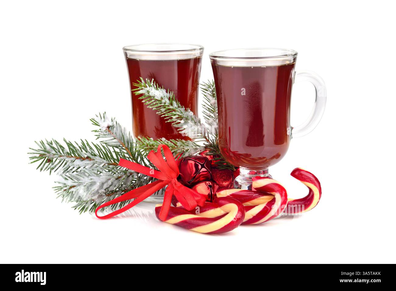 Christmas candy canes with two cups of tea and Christmas green tree ...