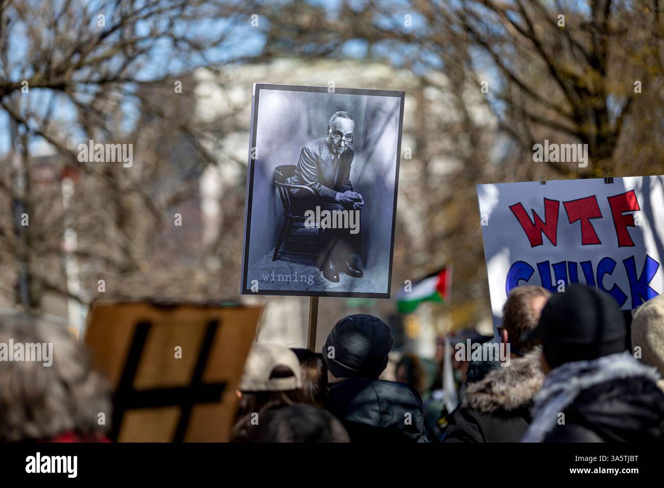 New York City, United States. 23rd Mar, 2025. Hundreds rally outside of Senate Minority Leader Chuck Schumer's (D-NY) home. Protestors are calling for Schumer to resign after what they call 'a devastating lack of leadership' after he voted for a GOP-written funding patch to avert a government shutdown, claiming it was the better of two bad options. (Photo by Michael Nigro/Pacific Press) Credit: Pacific Press Media Production Corp./Alamy Live News Stock Photo