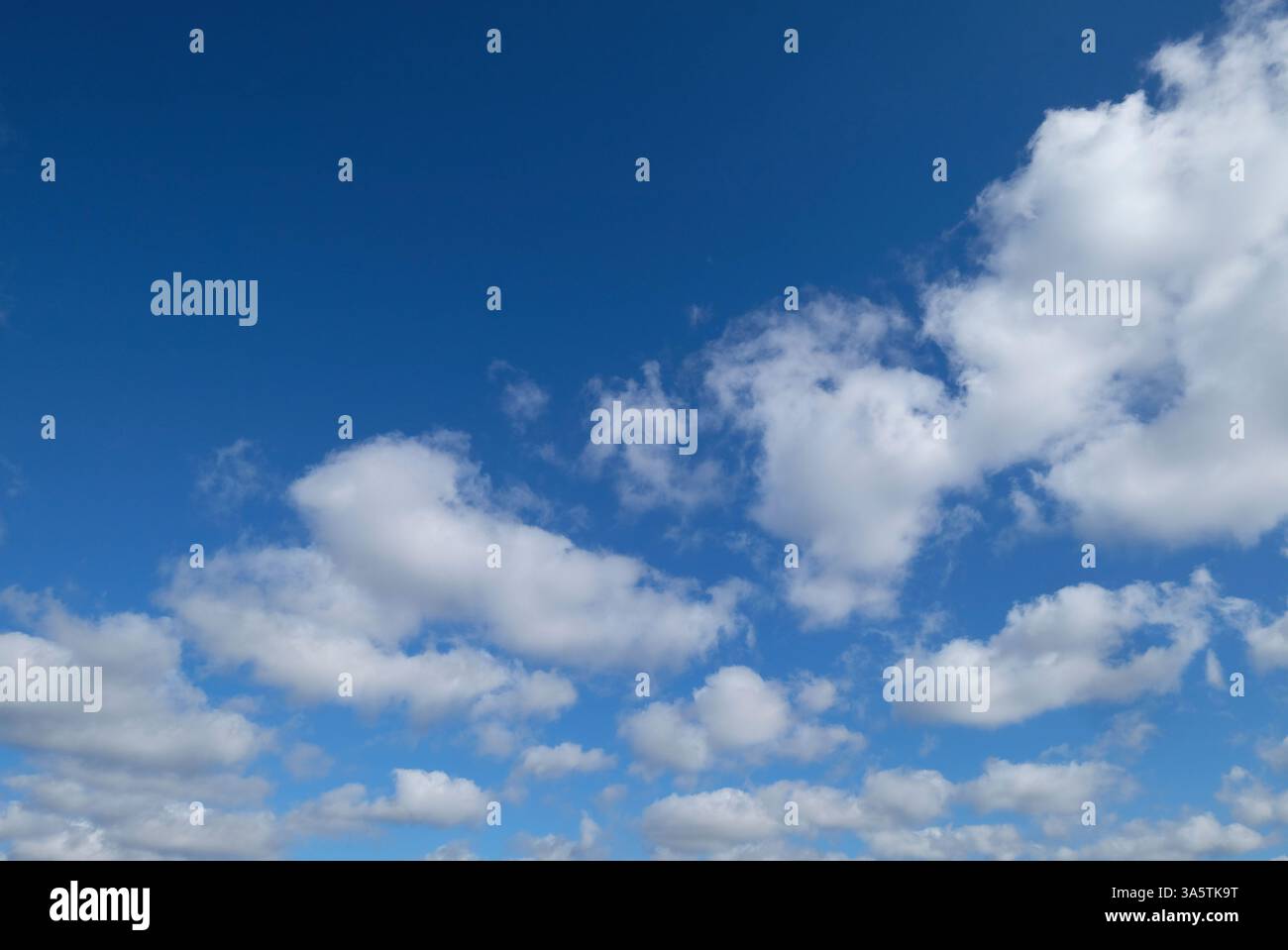 bright blue sky and white puffy clouds background Stock Photo