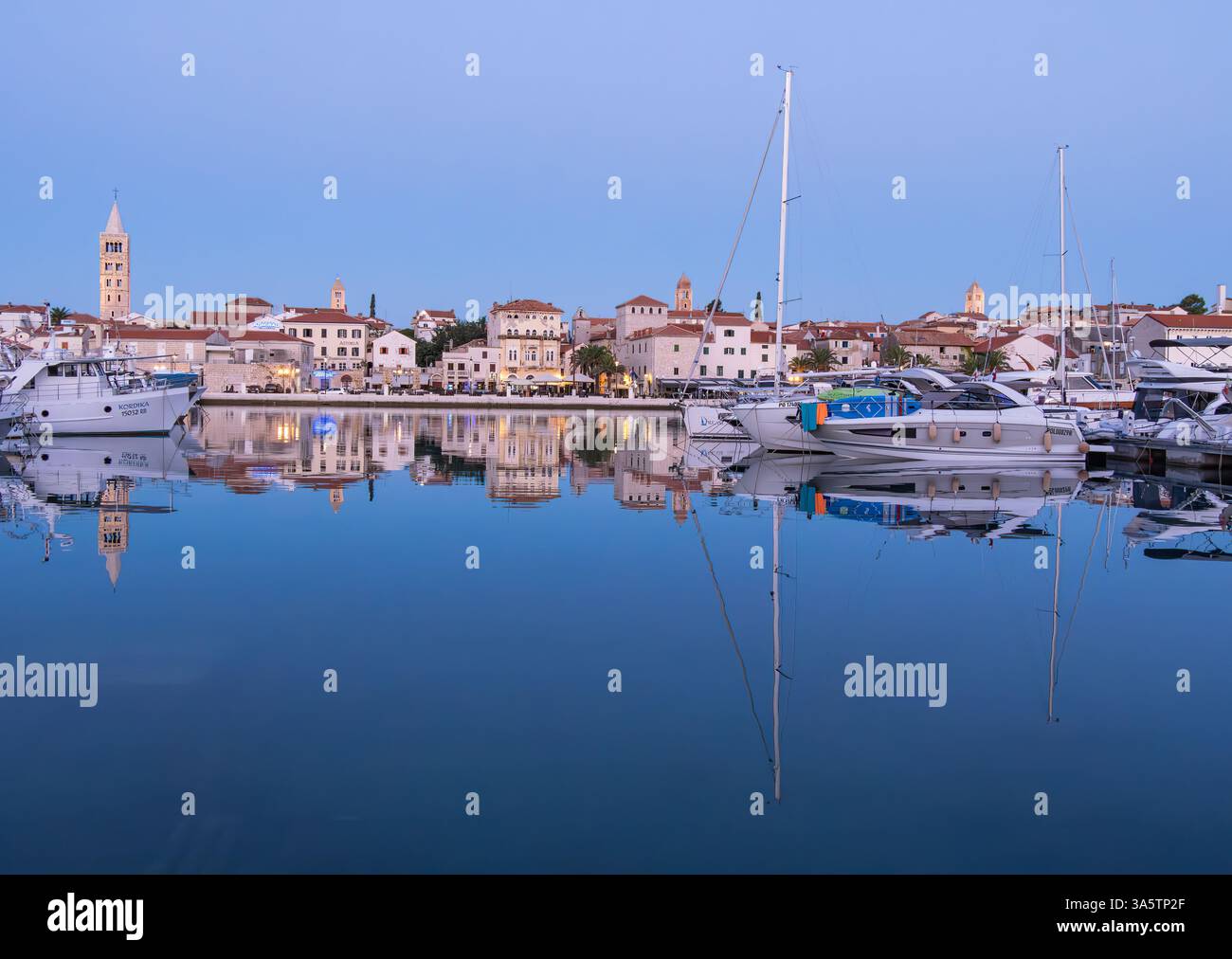 Rab, Croatia - 10 August 2024: A serene harbor scene at dusk with boats ...