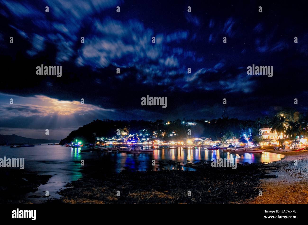 Boats are moored in the main Sabang Bay of PUERTO GALERA, on Mindoro Island, the PHILIPPINES Stock Photo