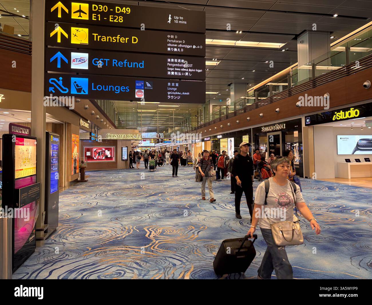 Singapore Changi Airport terminal with travelers walking and shopping ...
