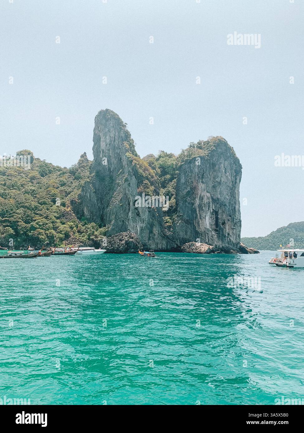 Phi Phi Islands, Thailand – Scenic Tropical Paradise with a Boat on the Water - Smartphone Captured Stock Image