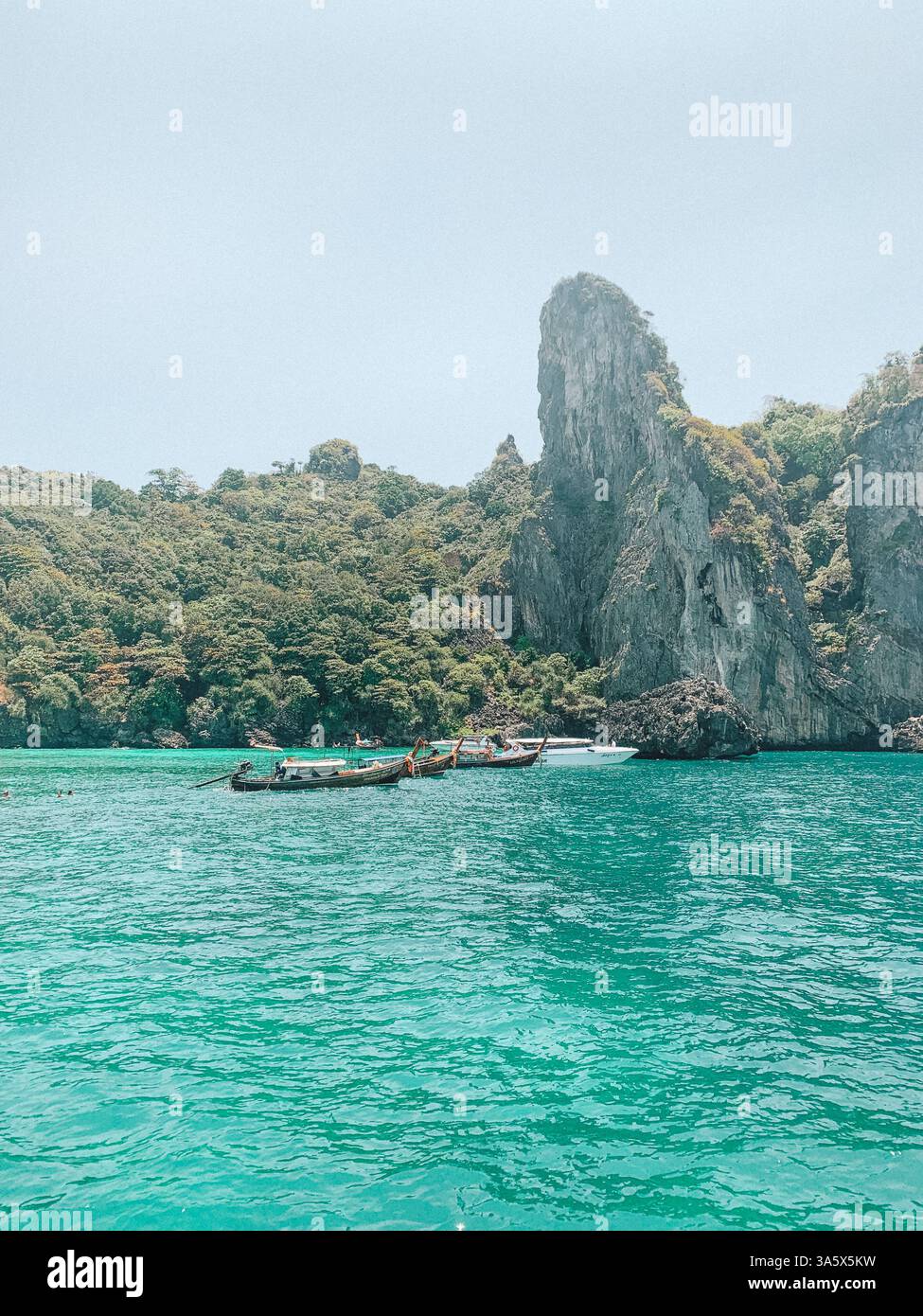 Phi Phi Islands, Thailand – Scenic Tropical Paradise with a Boat on the Water - Smartphone Captured Stock Image