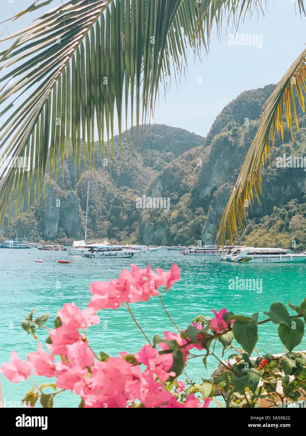 Phi Phi Islands, Thailand – Scenic Tropical Paradise with a Boat on the Water - Smartphone Captured Stock Image