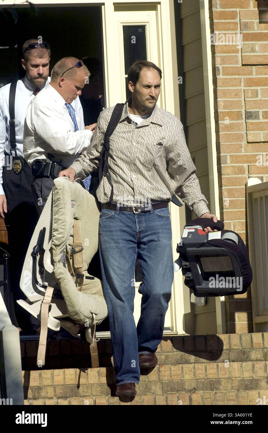 July 15, 2008 - Brad Cooper, front, is escorted out of his house by Cary police detectives on July 14, 2008, after an autopsy report came back identifying his wife, Nancy Cooper, as the body that was discovered Monday night in a pond in Cary, North Carolina. (Shawn Rocco/Raleigh News & Observer/MCT) (Credit Image: © Shawn Rocco/MCT/ZUMAPRESS.com) Stock Photo