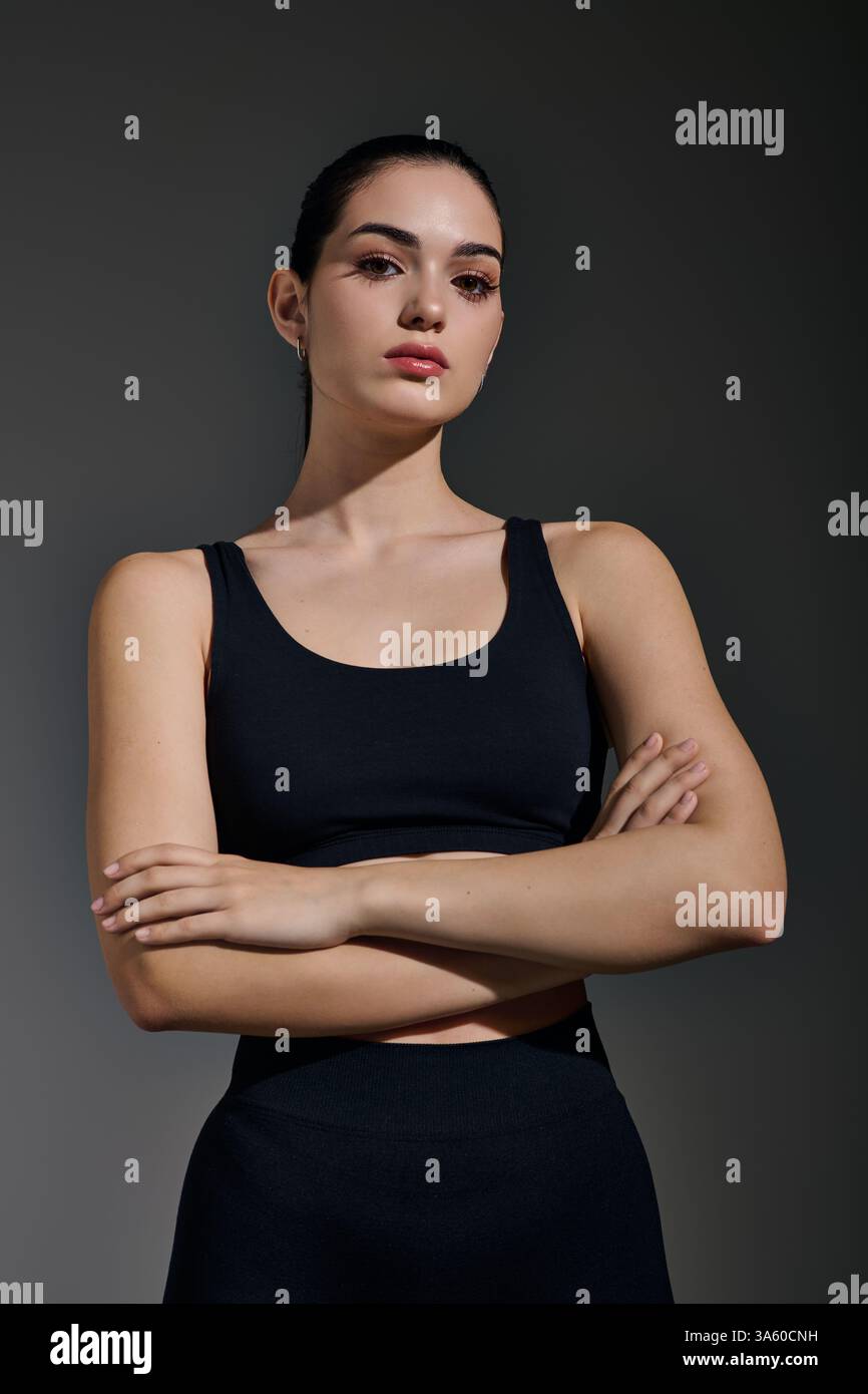 Confident fitness woman stands arms hires stock photography and images