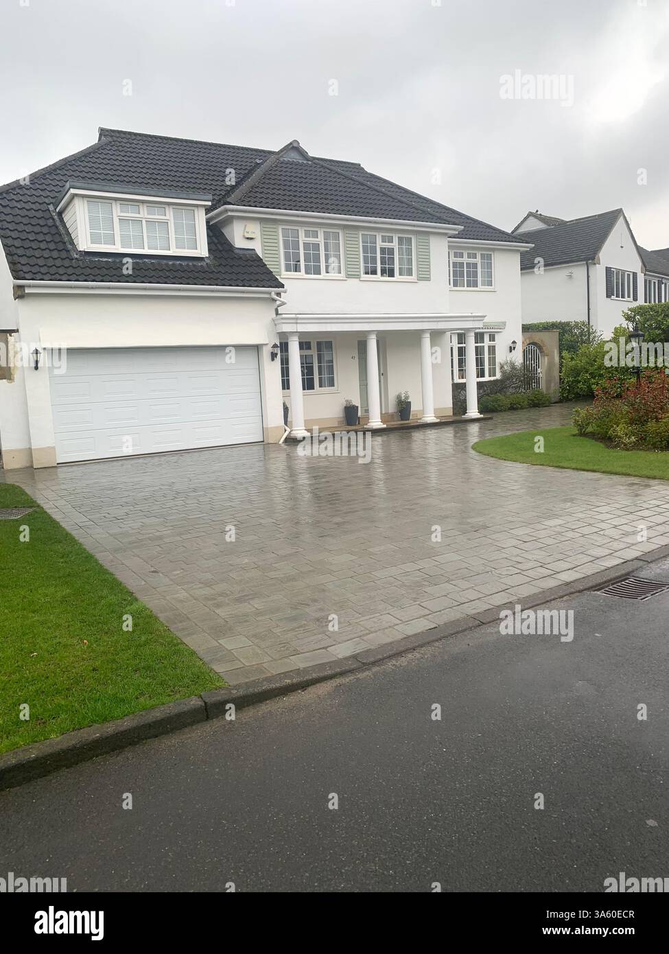 Guiseley houses homes home living life big large property lifestyle nice posh drive white painted wet cold weather Spring sign signs street road path - Smartphone Captured Stock Image