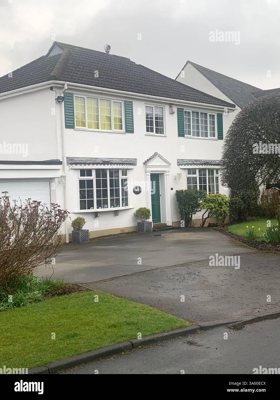 Guiseley houses homes home living life big large property lifestyle nice posh drive white painted wet cold weather Spring sign signs street road path - Smartphone Captured Stock Image