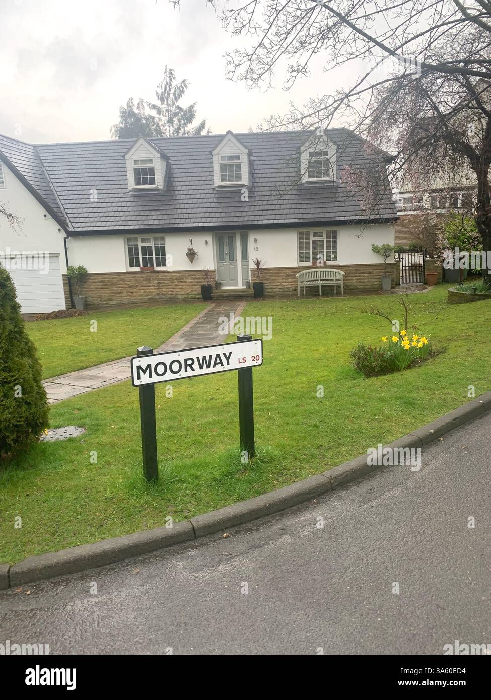 Guiseley houses homes home living life big large property lifestyle nice posh drive white painted wet cold weather Spring sign signs street road path - Smartphone Captured Stock Image