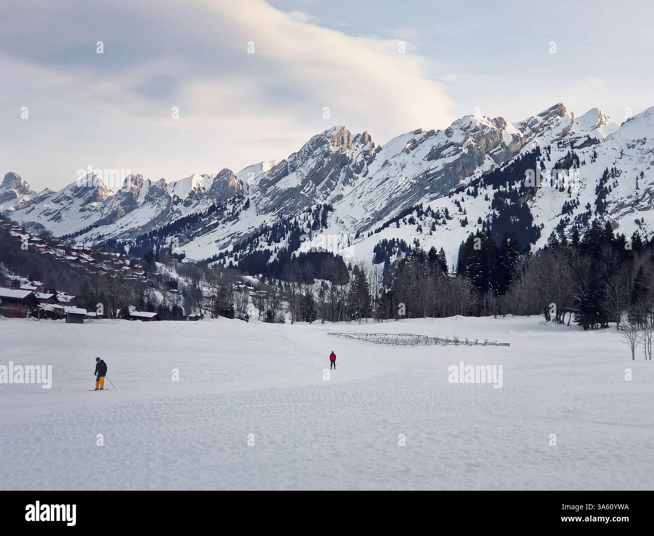 French Alps landscape of La Clusaz ski resort. Haute-Savoie Aravis mountains range in the eastern France. Snowy mounts landscape with rugged snow cove - Smartphone Captured Stock Image