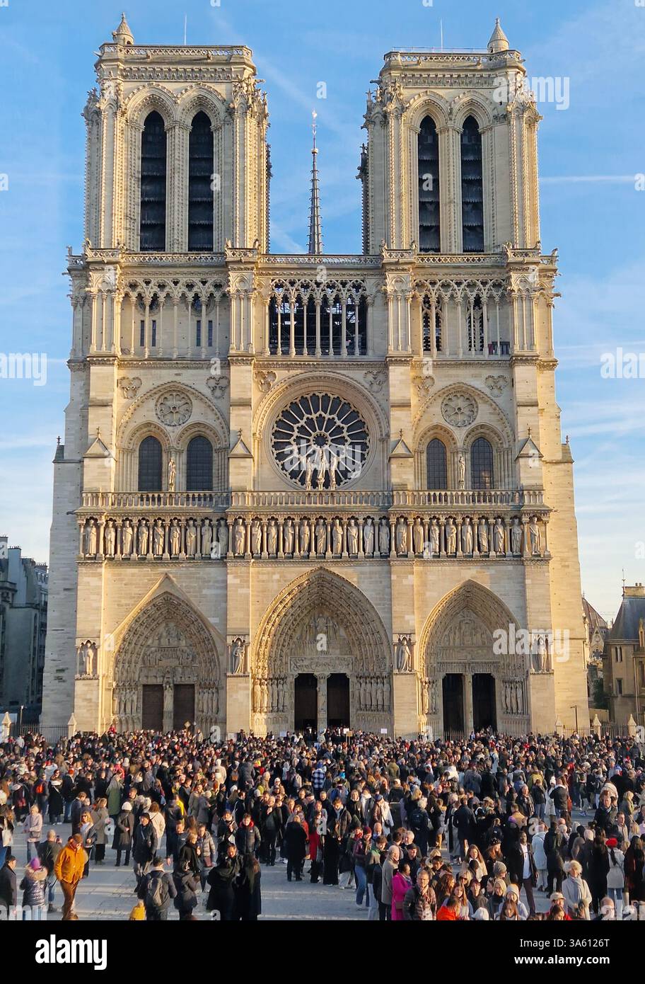 PARIS, FRANCE - DECEMBER 27, 2024 the iconic Notre-Dame Cathedral in Paris after restoration with a large crowd queue gathered at reopening in front o - Smartphone Captured Stock Image