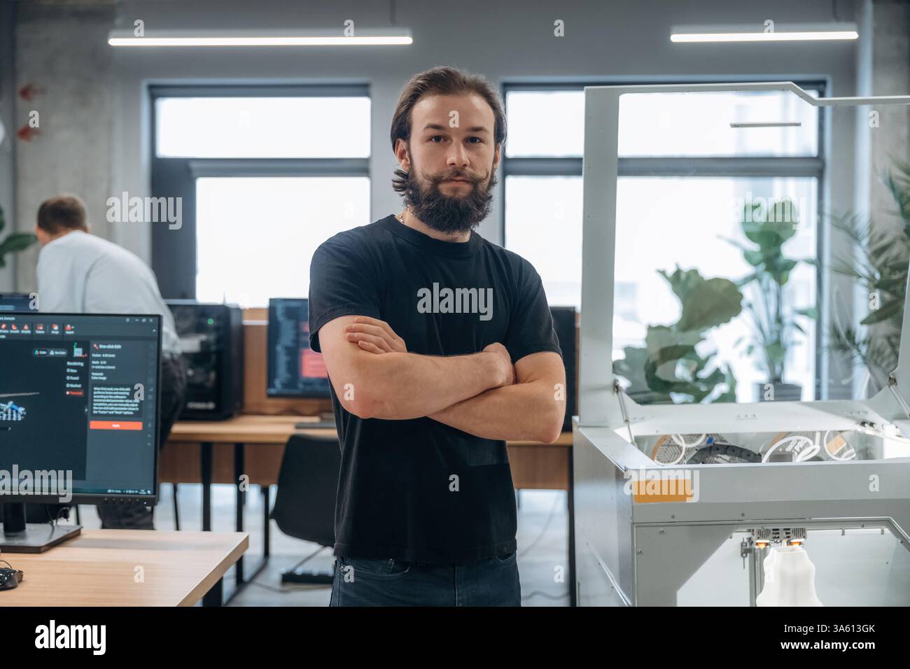 Man is in the office with 3d printer. Stock Photo