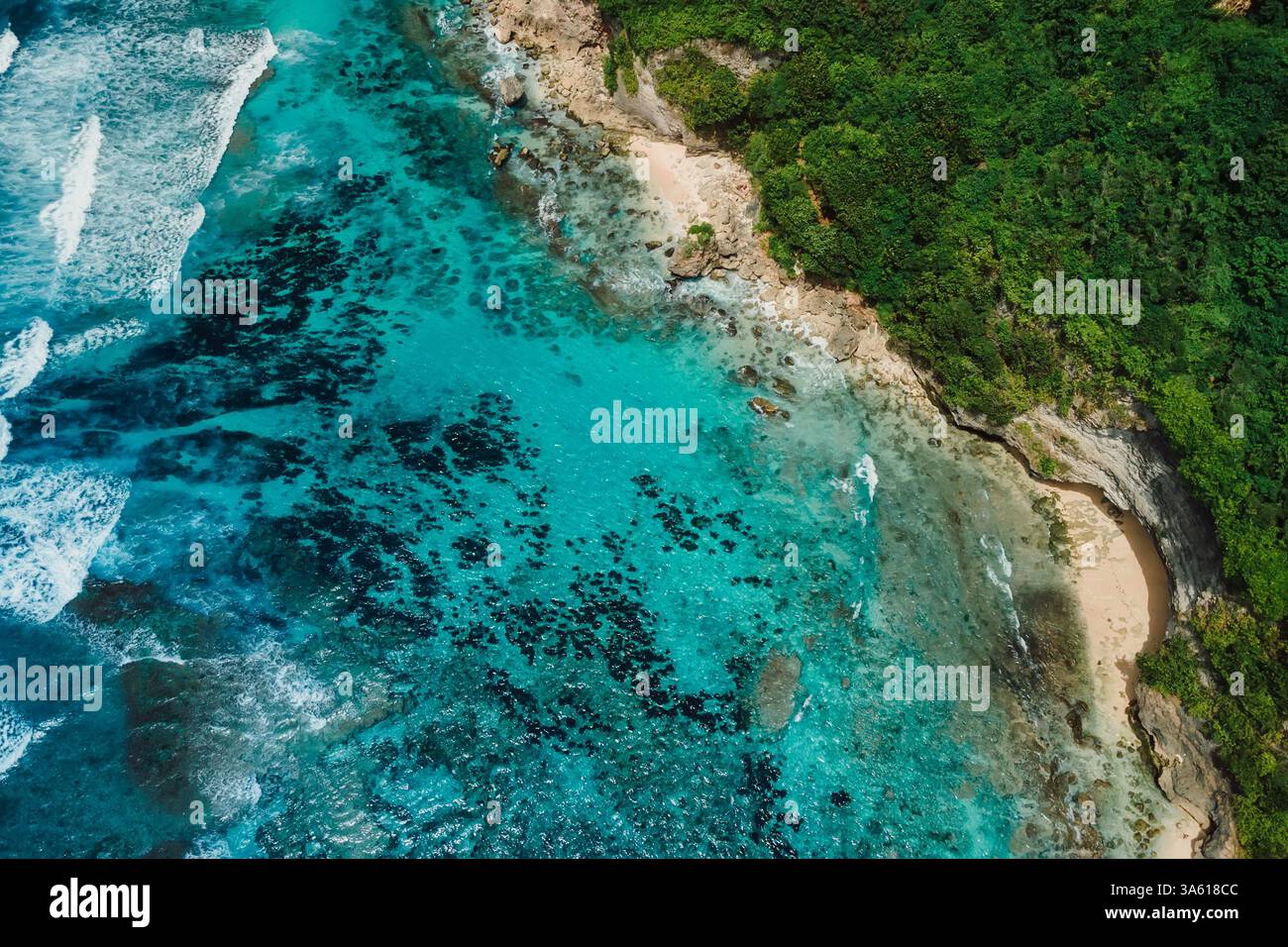 Beautiful coastline with turquoise clear ocean and green cliffs in Bali. Aerial view of tropical island Stock Photo