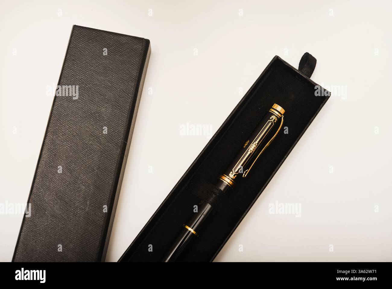 A gift pen in a box. A black fountain pen. Stock Photo