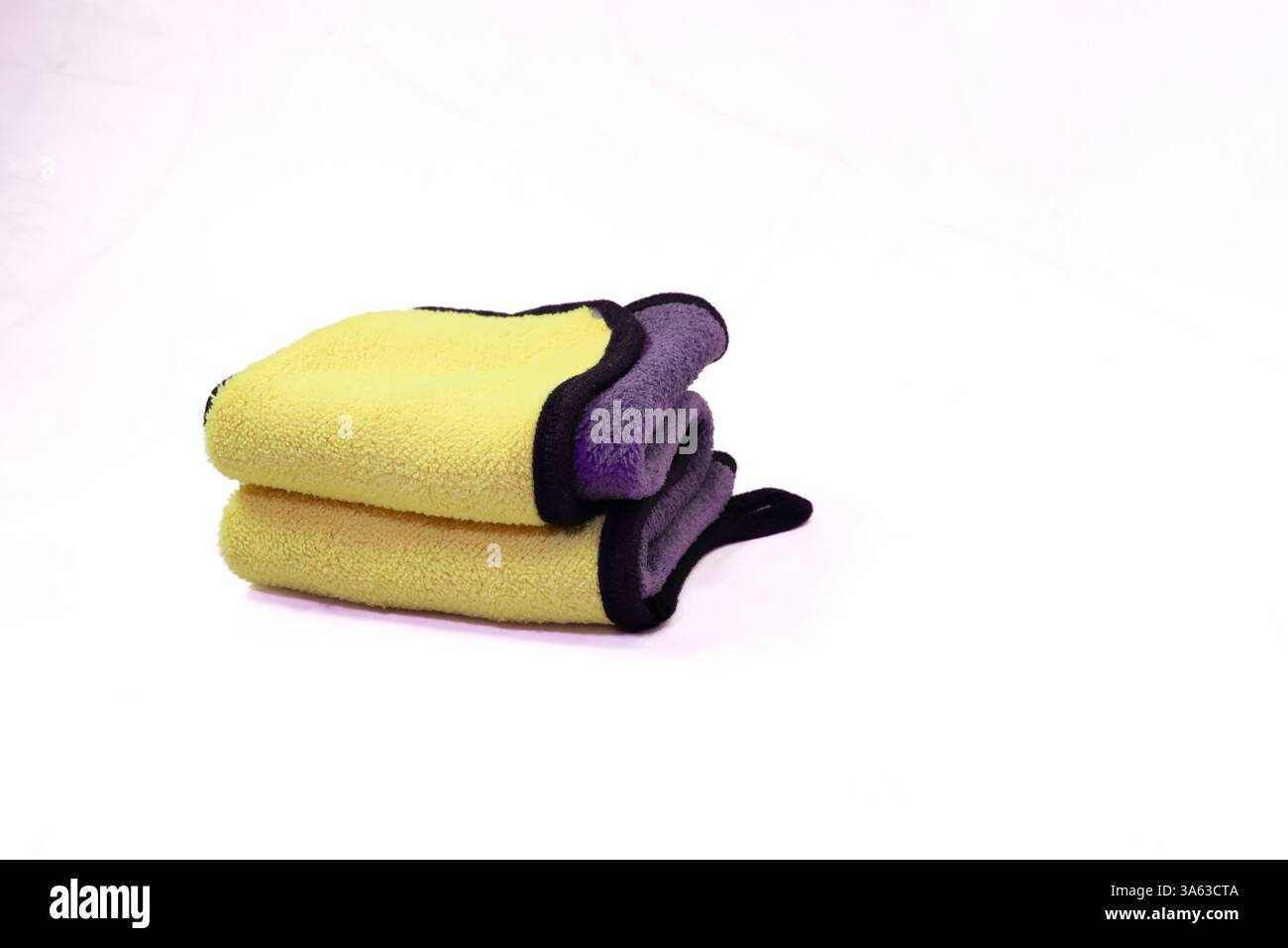 Stack of Folded Yellow and Gray Microfiber Cloths Stock Photo