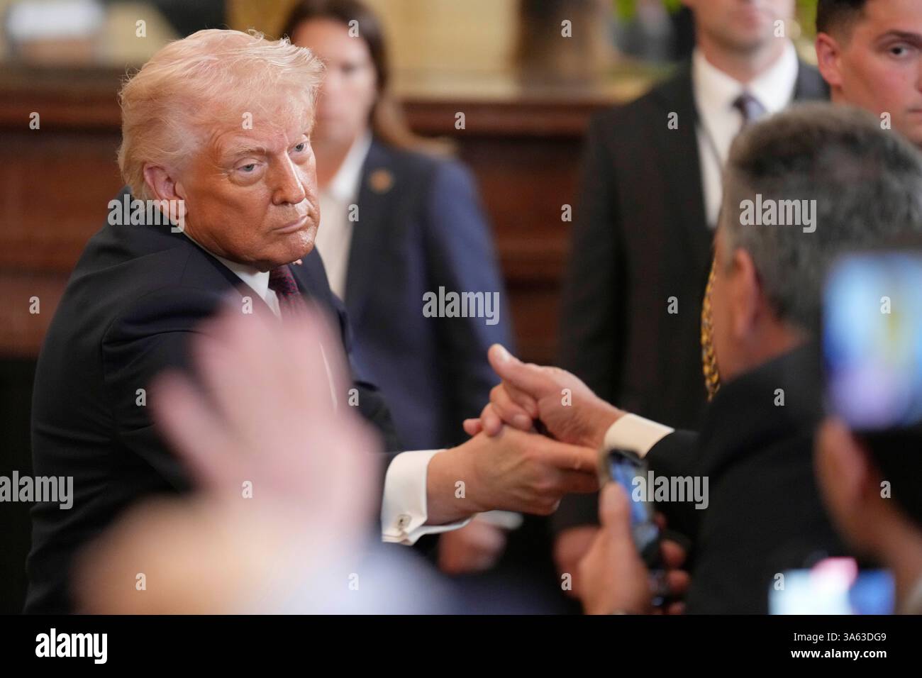 President Donald Trump greets members of the crowd at a reception ...