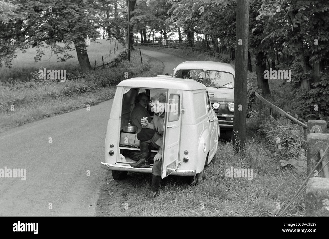 1954 Austin A30 LC Van scout child eating lunch after a hike in the woods England UK Stock Photo