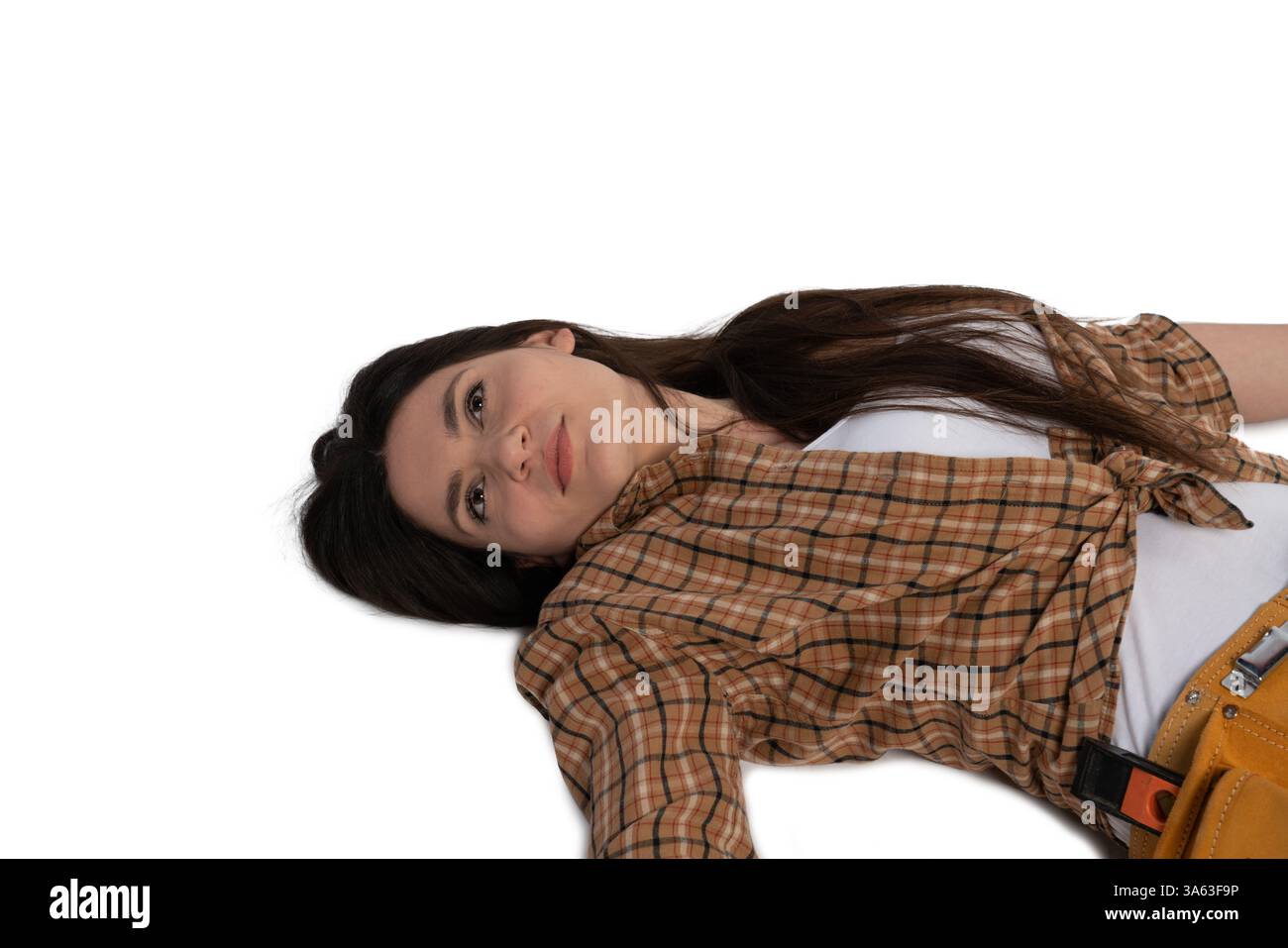 Daze Expression A female construction worker in a plaid shirt and tool belt lies on the ...