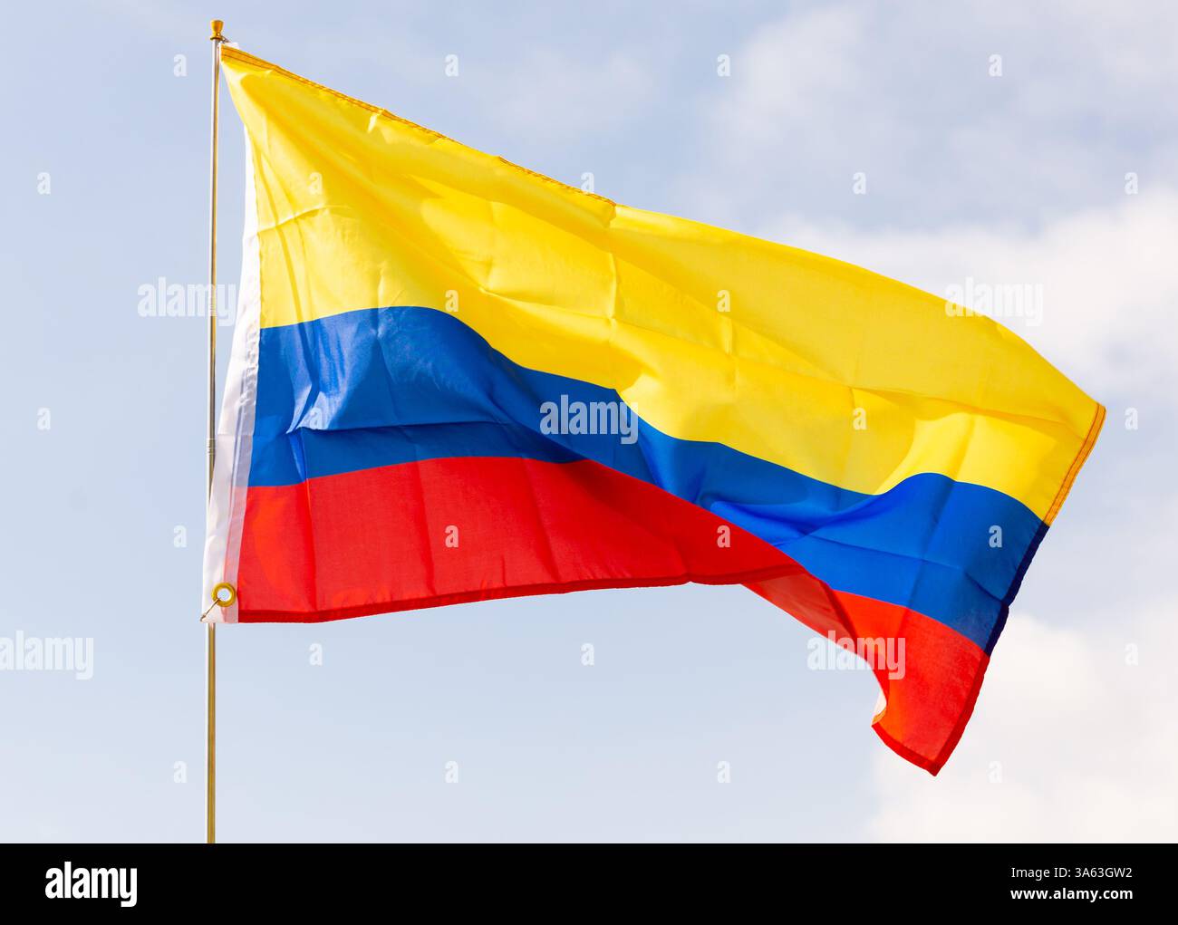National Flag Of Colombia Waving On Flagpole Against Blue Sky Stock