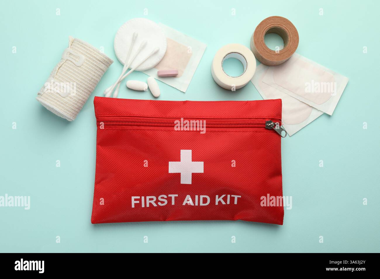 First aid kit. Different medical supplies on light blue background ...