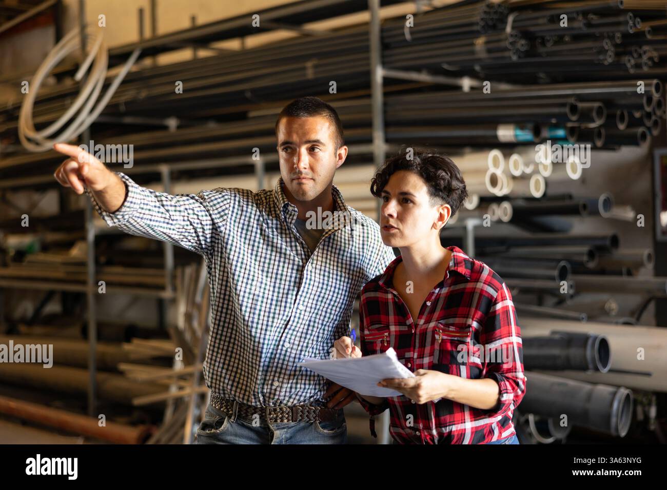 Man and woman verifying check list in warehouse Stock Photo