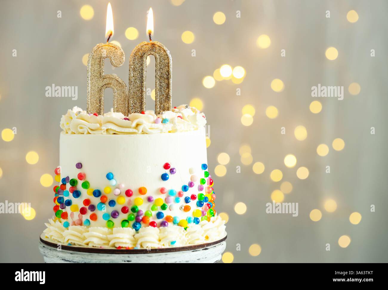60th birthday. Tasty cake with burning number shaped candles and ...