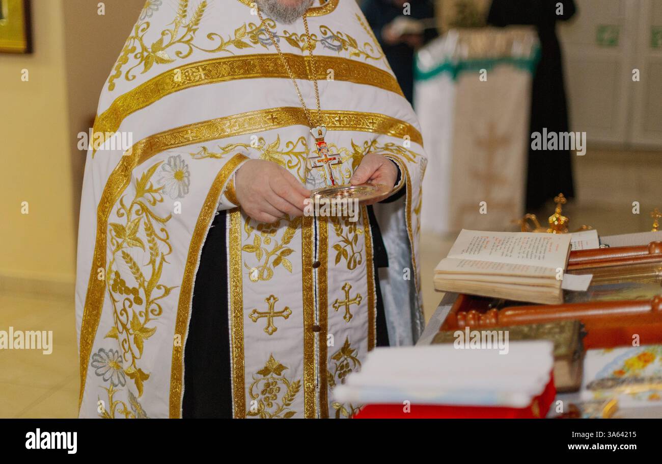 Priest Rings the priest carries wedding rings on a golden plate Stock Photo - Alamy