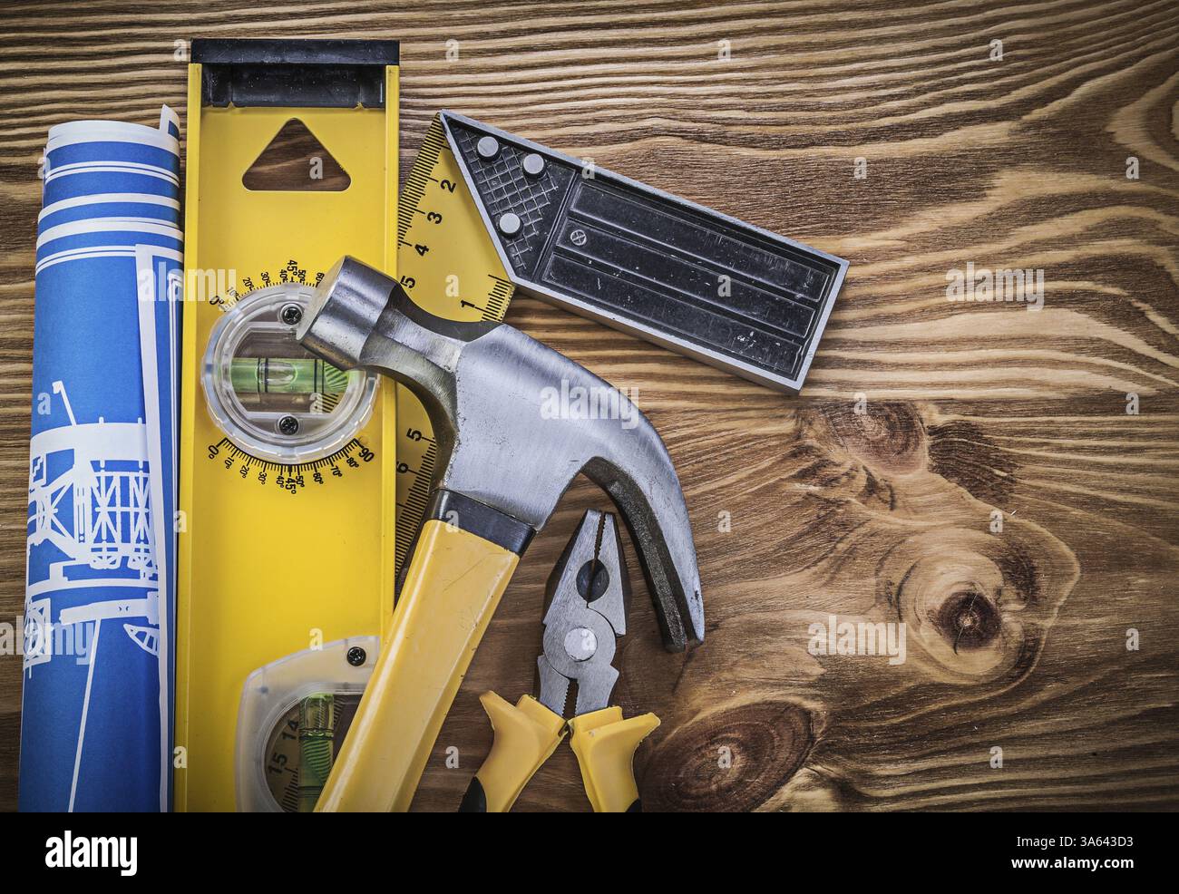 Blue blueprints construction level square ruler claw hammer gripping ...