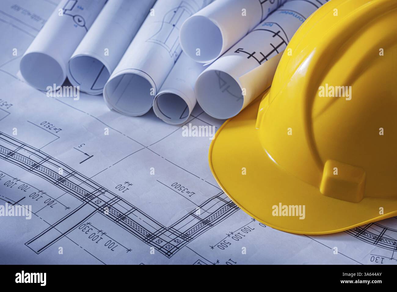 Rolled Blueprints And Construction Helmet Stock Photo - Alamy