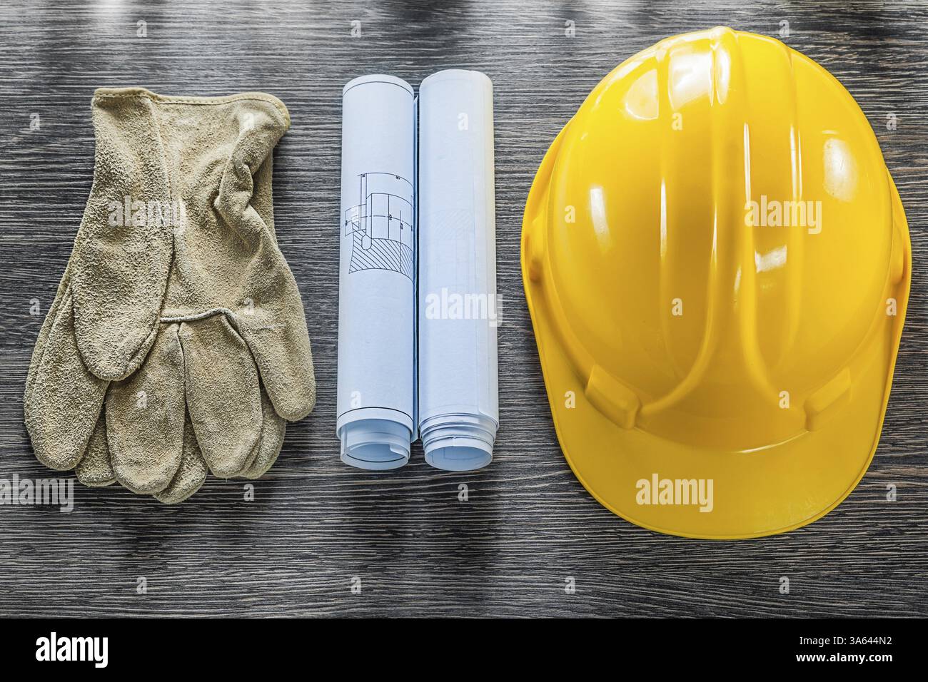 Safety gloves blueprints hard hat on wooden board Stock Photo - Alamy