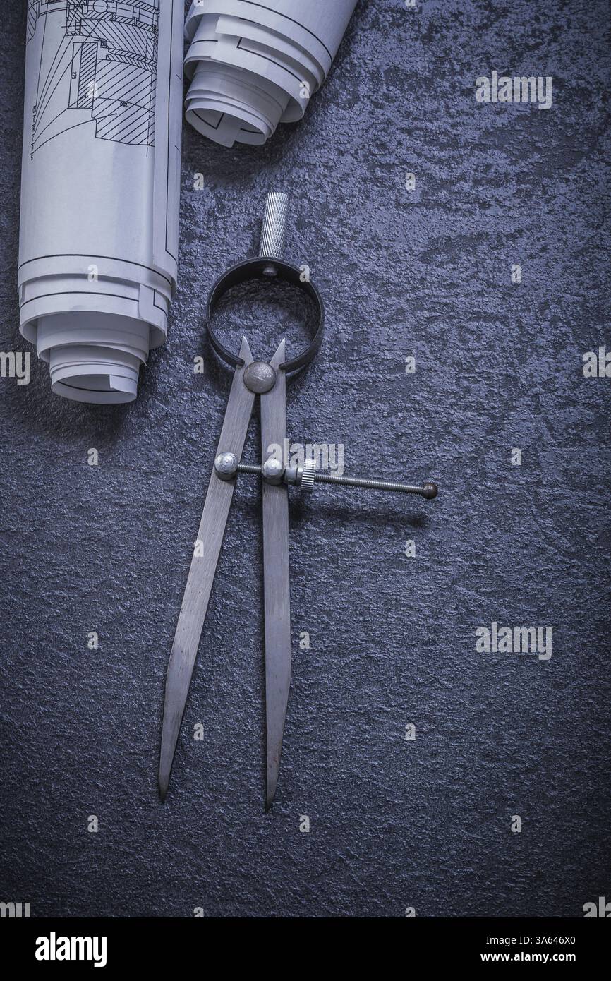 Blueprints drawing compass on black background construction concept Stock Photo