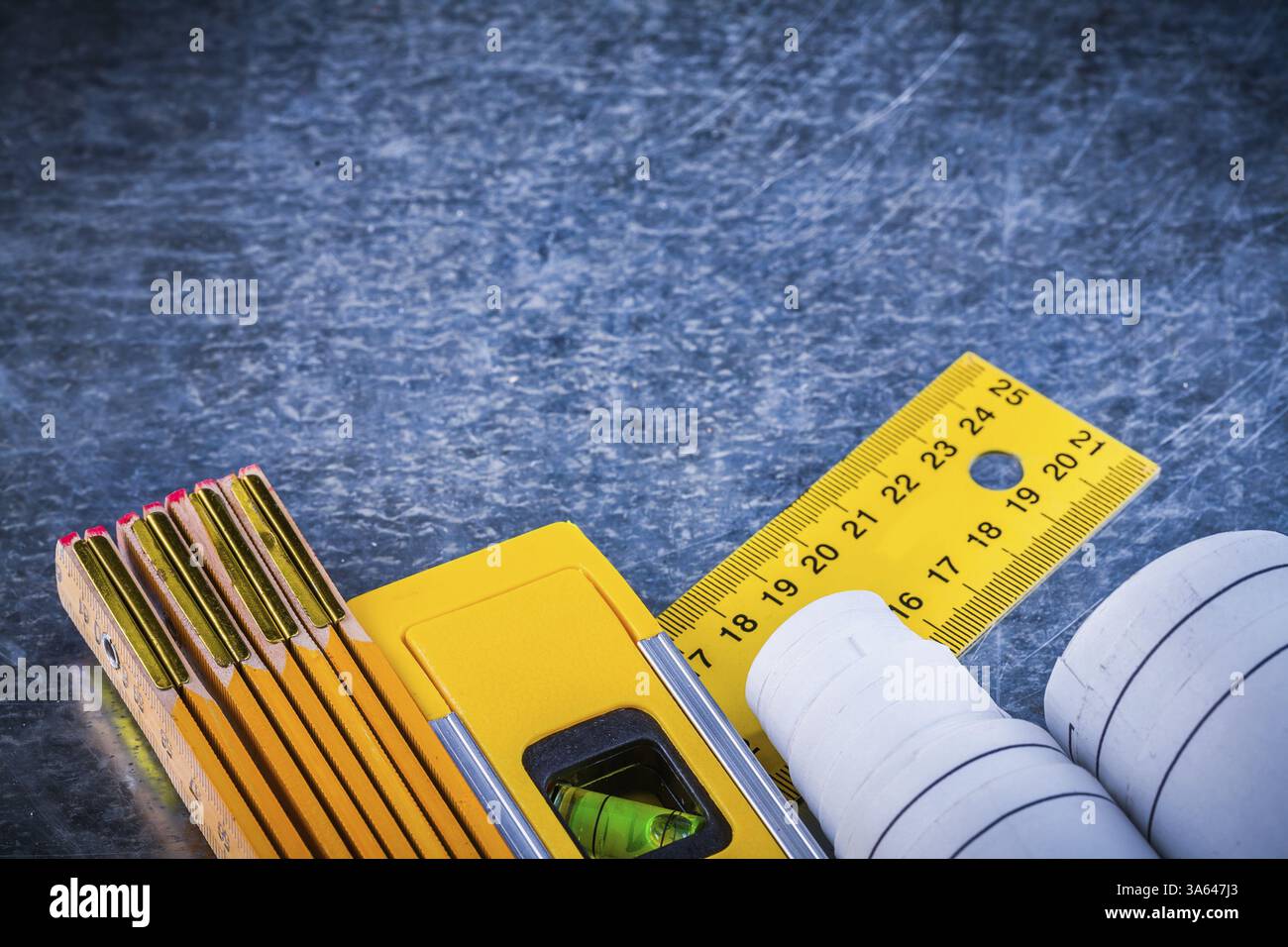 Blueprints yellow ruler construction level and wooden meter on metallic ...