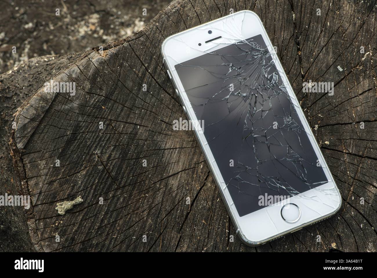 Broken white iphone glass on wood Stock Photo