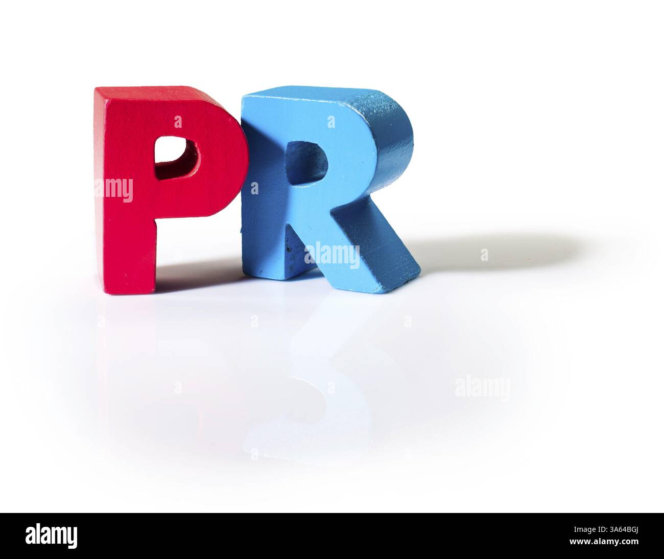 Multicolored text PR made of wood. White background Stock Photo
